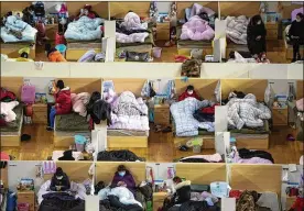  ?? XIAO YIJIU / XINHUA ?? Patients infected with the coronaviru­s take rest at a temporary hospital converted from Wuhan Sports Center in Wuhan. China reported 1,886 new virus cases and 98 more deaths in its update Tuesday on the disease outbreak.