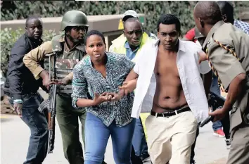  ?? THOMAS MUKOYA Reuters ?? PEOPLE are evacuated at the scene where explosions and gunshots were heard at the DusitD2 hotel compound in Nairobi, Kenya, in a terror attack in which five people were killed. |