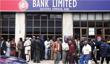  ?? Picture: REUTERS ?? DAILY PASTIME: People queue to draw money outside a bank in Harare, Zimbabwe, yesterday.