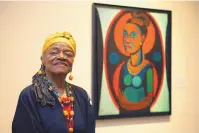 ?? JACQUELYN MARTIN/ASSOCIATED PRESS ?? Faith Ringgold poses in front of a painted self-portrait during a press preview of her exhibition, “American People, Black Light: Faith Ringgold’s Paintings of the 1960s” at the National Museum of Women in the Arts in Washington in June 2013.