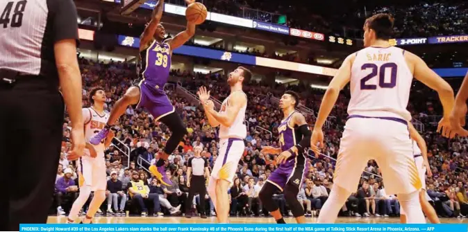  ??  ?? PHOENIX: Dwight Howard #39 of the Los Angeles Lakers slam dunks the ball over Frank Kaminsky #8 of the Phoenix Suns during the first half of the NBA game at Talking Stick Resort Arena in Phoenix, Arizona. — AFP