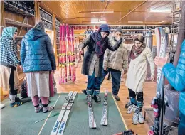  ??  ?? People try on rental ski equipment in February at Gulmarg.