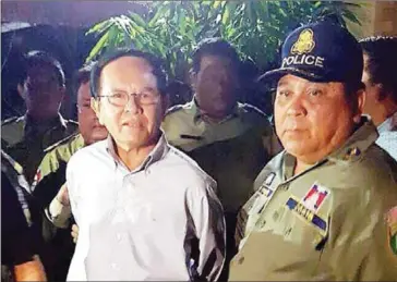  ?? AFP ?? Opposition leader Kem Sokha is escorted by police following his midnight arrest in September.