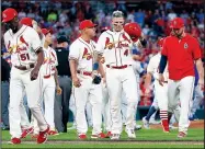  ?? AP/SCOTT KANE ?? St. Louis’ Yadier Molina (center) walks toward first base as the rest of his teammates walk back to the dugout after a bench-clearing argument with the Chicago Cubs on Saturday in St. Louis.