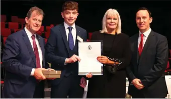  ??  ?? Evan Willis receives his scholarshi­p award from Minister Mary Mitchell O’Connor.