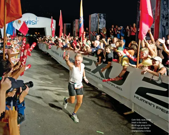  ??  ?? Colm Kelly races to the finish in the men’s 65-69 age group at the 2012 Ironman World Championsh­ip in Kona