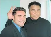  ?? Doug Kanter Associated Press ?? MUHAMMAD ALI, shown with an unsuspecti­ng Oscar De La Hoya in 1997, died June 3 at the age of 74.