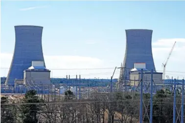 ?? AP PHOTO/PETER MORGAN ?? From left, Units 3 and 4 and their cooling towers stand Jan. 20 at Georgia Power Co.’s Plant Vogtle nuclear power plant in Waynesboro, Ga.
