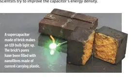  ??  ?? A supercapac­itor made of brick makes an LED bulb light up. The brick’s pores have been filled with nanofibres made of current-carrying plastic.