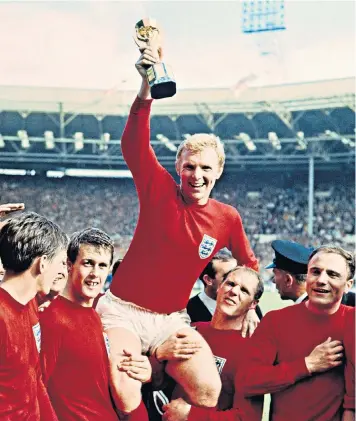  ??  ?? Ray Wilson, right, and Geoff Hurst lift England captain Bobby Moore as they celebrate victory in the 1966 World Cup final