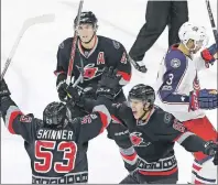  ?? AP PHOTO ?? Carolina Hurricanes’ Teuvo Teravainen (86), of Finland, celebrates with Jeff Skinner (53) and Victor Rask, top, of Sweden, following Skinner’s goal while Columbus Blue Jackets’ Seth Jones (3) skates away during the third period of an NHL game in...