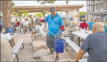  ?? Rachel Aston Las Vegas Review-Journal @rookie__rae ?? Harlan Thompson picks up trash Thursday at the Courtyard Homeless Resource Center. Thompson was homeless and used the Courtyard to get off the streets.