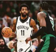  ?? Maddie Meyer / TNS ?? The Nets’ Kyrie Irving (11) dribbles downcourt against the Celtics’ Jaylen Brown during Sunday’s playoff game.