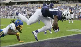  ?? AP PHOTOS ?? TCU running back Kyle Hicks scores a touchdown against South Dakota State defensive back Anthony Washinton during the first half of the game Saturday in Fort Worth, Texas.