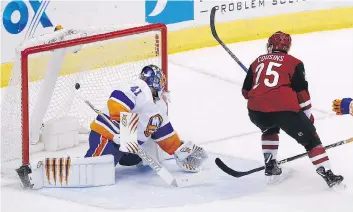  ?? ROSS D. FRANKLIN/THE ASSOCIATED PRESS ?? Arizona Coyotes centre Nick Cousins scores the OT game winner against New York Islanders goaltender Jaroslav Halak Monday in Glendale, Ariz.