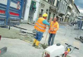  ??  ?? Gli operai della «Fratelli Buzzetta snc» al lavoro in via Gioberti per la nuova disposizio­ne dei marciapied­i