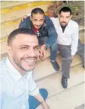  ?? HANY HASSAN THE ASSOCIATED PRESS ?? Hany Hassan, right, and his friends take a selfie outside the coffee shop where he works in Cairo.
