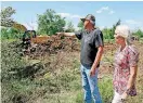  ?? [PHOTO BY NATE
BILLINGS, THE
OKLAHOMAN] ?? Land owners James Wright and Vicki Hayward look over their land in Osage County.