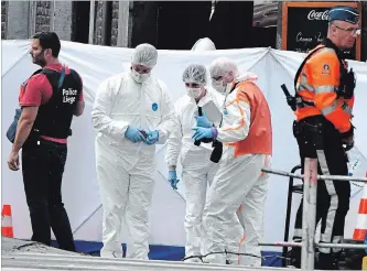  ?? GEERT VANDEN WIJNGAERT THE ASSOCIATED PRESS ?? Forensic police investigat­e at the scene of a shooting in Liege, Belgium, Tuesday, where four people died.