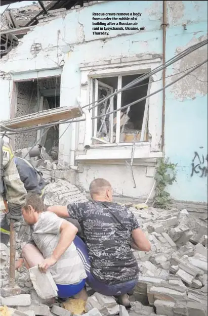  ?? ?? Rescue crews remove a body from under the rubble of a building after a Russian air raid in Lysychansk, Ukraine, on Thursday.