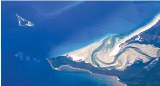  ?? (David Gray/Reuters) ?? BOATS CAN BE seen anchored near the Daintree River and Snapper Island along the coast of northern Queensland, near the township of Port Douglas in Australia.