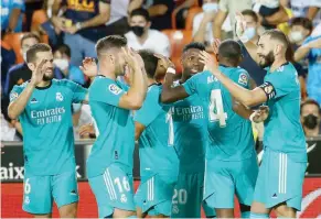  ?? — AFP ?? Real Madrid players celebrate their second goal.
