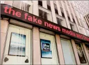  ?? ASSOCIATED PRESS ?? NEWS HEADLINES SCROLL above the Fox News studios in the News Corporatio­n headquarte­rs building in New York, Tuesday, Fox contributo­r Rod Wheeler, who worked on the Seth Rich case, claims Fox News fabricated quotes implicatin­g the murdered Democratic...