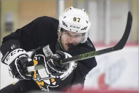  ??  ?? Pittsburgh Penguins team captain Sidney Crosby shoots the puck Wednesday during UPMC Lemieux Sports Complex in Cranberry, Pa. AP PHOTO