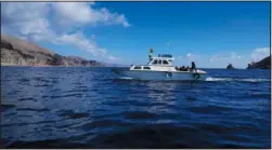  ?? ?? A boat travels
July 27 on Lake Titicaca.