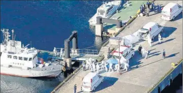  ?? AP ?? Medical workers take a passenger who tested positive for coronaviru­s from the cruise ship Diamond Princess at Yokohama Port in Japan.