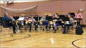  ?? SUBMITTED PHOTO DERRIAN HALLAS ?? Instructor Jim Schmid and the St. Patrick’s School Grade 5 Guitar Program rocked Rotary Music Festival on Friday.