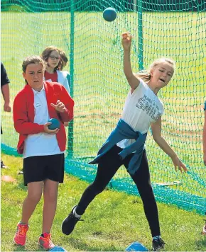  ??  ?? Angus pupils try their hand at shot-putt and the mini assault course.