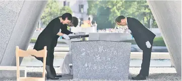  ??  ?? Hiroshima Mayor Kazumi Matsui (right) offers a new list of A-bomb dead, people who died since last year’s anniversar­y from the side effects of radiation, during the 72nd anniversar­y memorial service for the atomic bomb victims at the Peace Memorial...