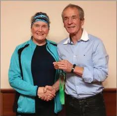  ??  ?? Mary Nolan Hickey receives her over-65 Leinster bronze medal from Terry Kavanagh.