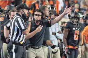  ?? SARAH PHIPPS/THE OKLAHOMAN ?? Oklahoma State coach Mike Gundy argues a penalty in the overtime period of a 41-34 loss to Texas last season in Stillwater.