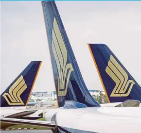  ?? BLOOMBERG PIC ?? Singapore Airlines’s net debt may hit about S$660 million by the end of March next year, compared with net cash of about S$3.3 billion for the 12 months through March last year.