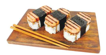  ?? SHUTTERSTO­CK.COM PHOTOS ?? For a Japanese spin with an American classic, try Spam musubi. The canned meat product is placed on top of a block of rice and wrapped with seaweed used for sushi.