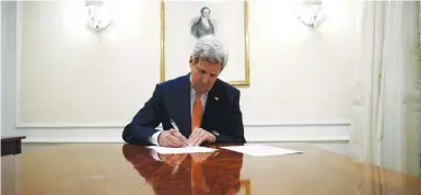  ??  ?? THEN-SECRETARY of state John Kerry signs the Iran deal in 2016.