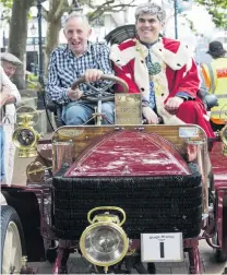  ??  ?? Chains gang . . . Brighton Veteran Car Rally organiser Colin Winter drives Dunedin Mayor Aaron Hawkins.