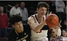  ?? ASHLEY LANDIS — THE ASSOCIATED PRESS ?? Colorado guard KJ Simpson, left, will be one of several Buffs players aiming to slow USC’S Drew Peterson when the teams collide at the CU Events Center.