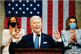  ?? MELINA MARA/THE WASHINGTON POST VIA AP, POOL ?? President Joe Biden addresses a joint session of Congress in the House Chamber at the U.S. Capitol, backed by Vice President Kamala Harris (left) and Speaker Nancy Pelosi, D-calif., Wednesday night. Attendance was limited to about 200 as a COVID-19 precaution.