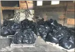  ?? PHOTO PROVIDED BY TOM DEHAAS ?? Constructi­on garbage bags are filled with granular pesticides that had been stored in their original bags for an estimated 30 years in a barn at the former Champion Farm in Perry Village.