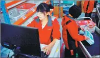  ??  ?? Workers of online marketplac­e JD.com Inc check goods at a warehouse in Langfang, Hebei province.