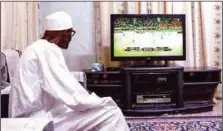  ??  ?? Buhari watching the Nigeria-Cameroun match on his 32" TV