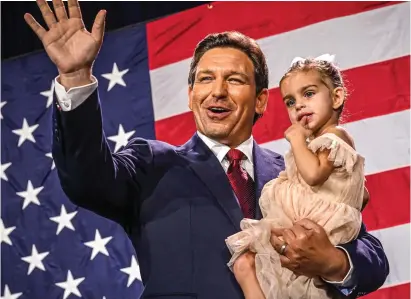  ?? ?? Victory wave: Ron DeSantis holds his two-year-old daughter Mamie as he celebrates his triumph