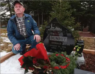  ?? The Canadian Press ?? Tom Hearn visits the gravesite of his friend, Don Dunphy, in Mitchell’s Brook, N.L. A public inquiry into the police shooting of Dunphy starts today.