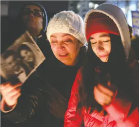  ?? Chris Helg ren / reuters ?? Mourners attend an outdoor vigil in Toronto for the victims of the Ukrainian passenger jet which crashed in Iran.