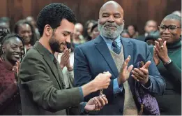  ?? PROVIDED BY TOBIN YELLAND/FOCUS FEATURES ?? Roger (David Alan Grier, right) brings Aren (Justice Smith) into a secret organizati­on of Black members who make white people’s lives comfortabl­e in the comedy “The American Society of Magical Negroes.”