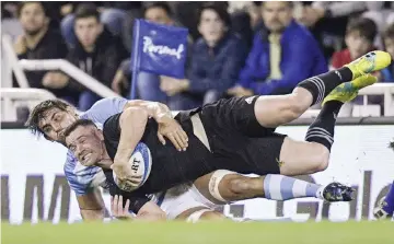  ?? — AFP photo ?? New Zealand’s All Blacks centre Ryan Crotty (front) is tackled by Argentina’s Los Pumas flanker Pablo Matera during their Rugby Championsh­ip match at Jose Amalfitani stadium in Buenos Aires, Argentina in this Sept 29 file photo.