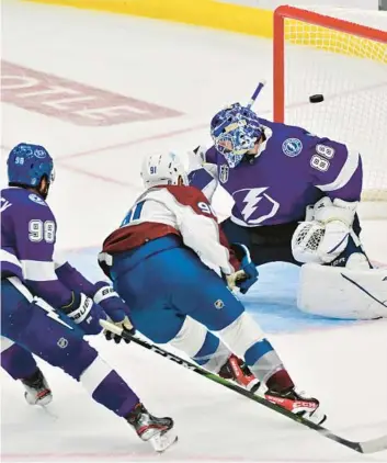  ?? JULIO AGUILAR/GETTY ?? Nazem Kadri scores the winning goal for the Avalanche in Game 4 of the Stanley Cup Final on Wednesday.